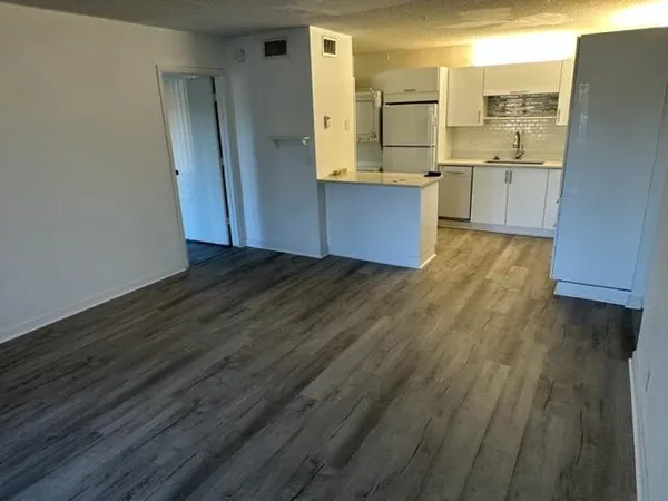 a view of kitchen with wooden floor