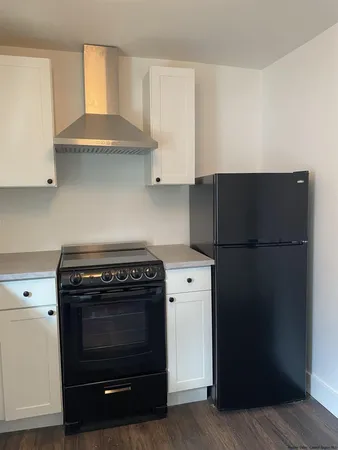 a kitchen with a stove and a refrigerator