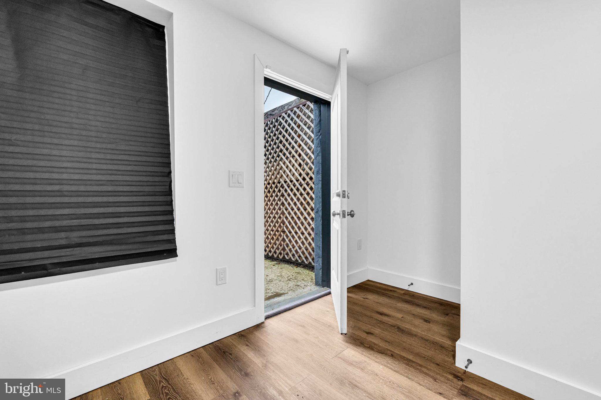 2801 Round Road Baltimore, MD 21225 - Photo 10 of 29 a view of a hallway with wooden floor and glass door