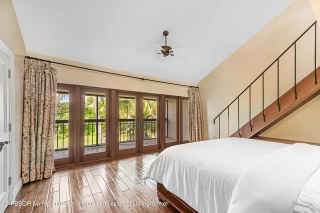 a bedroom with bed and a wooden floor