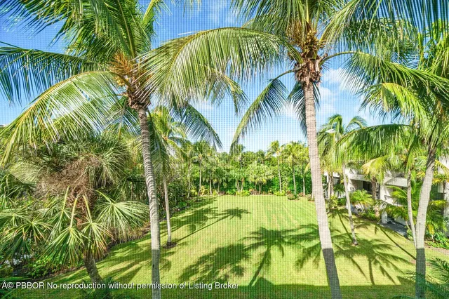 a bathroom with a granite countertop sink a large mirror and a large window