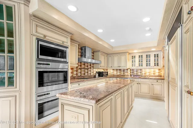 a bathroom with a granite countertop sink a toilet a mirror and shower