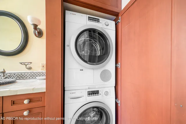 a view of a house with brick walls and a yard with plants