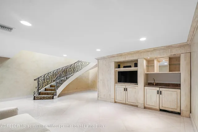 a view of an empty room with stairs and ventilation