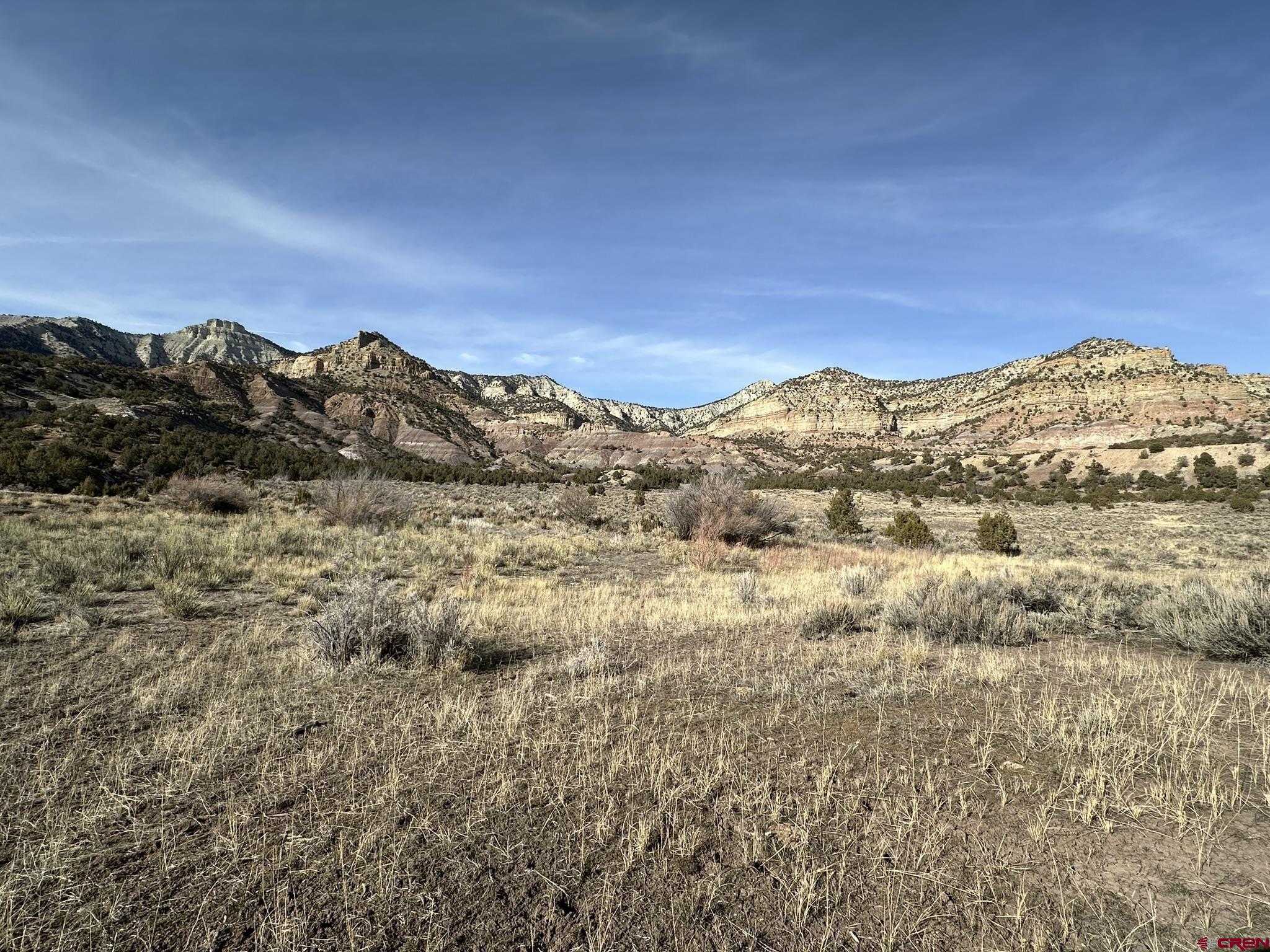 Tbd V Road De Beque, CO 81624 - Photo 19 of 22 a view of a large building with mountains in the background