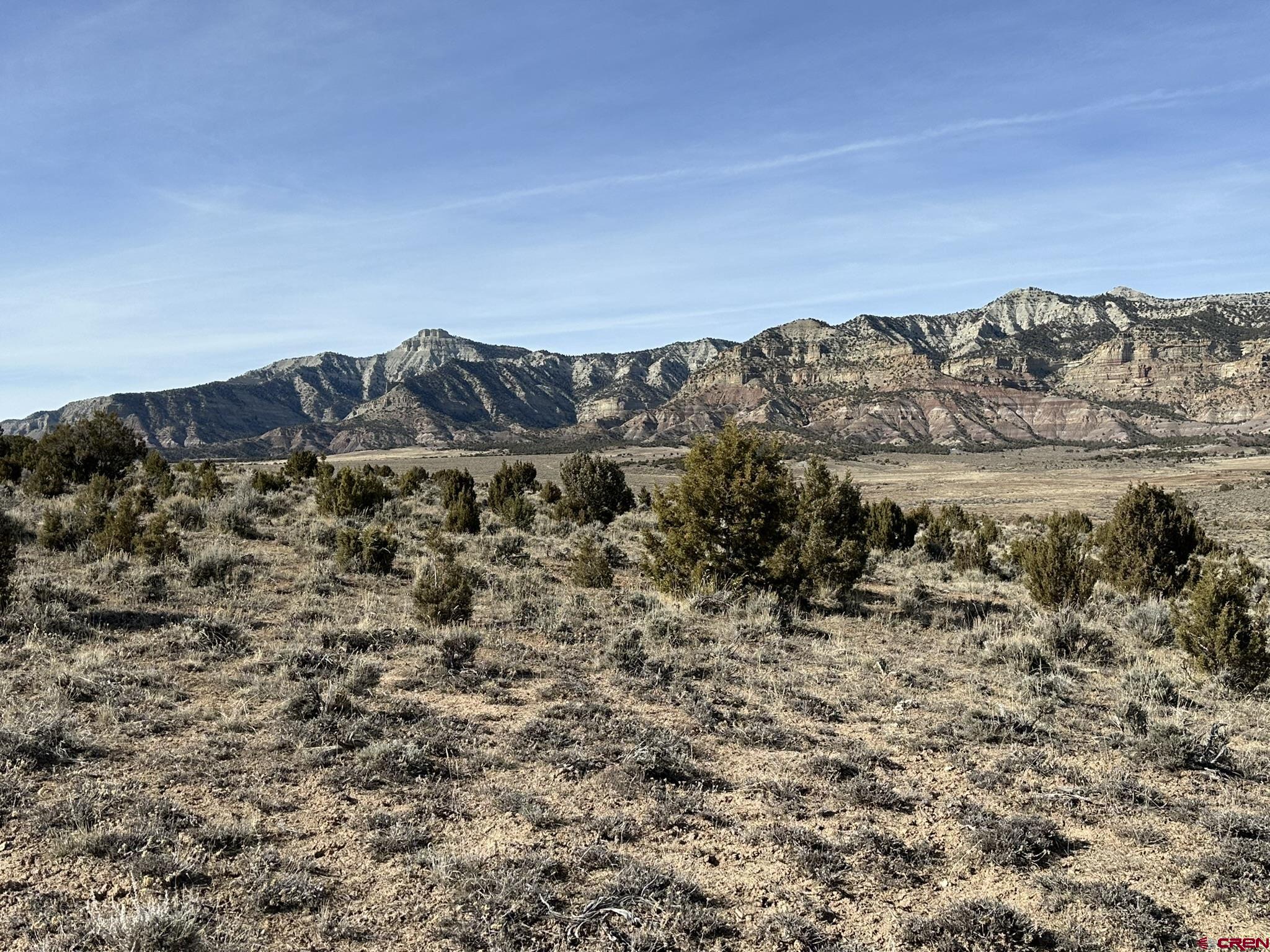 Tbd V Road De Beque, CO 81624 - Photo 6 of 22 a view of a large building with mountains in the background