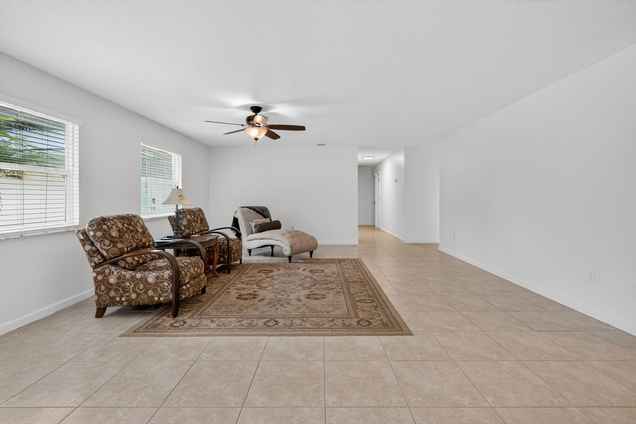 17391 Alexander Run Jupiter, FL 33478 - Photo 3 of 55 a living room with furniture and a chandelier