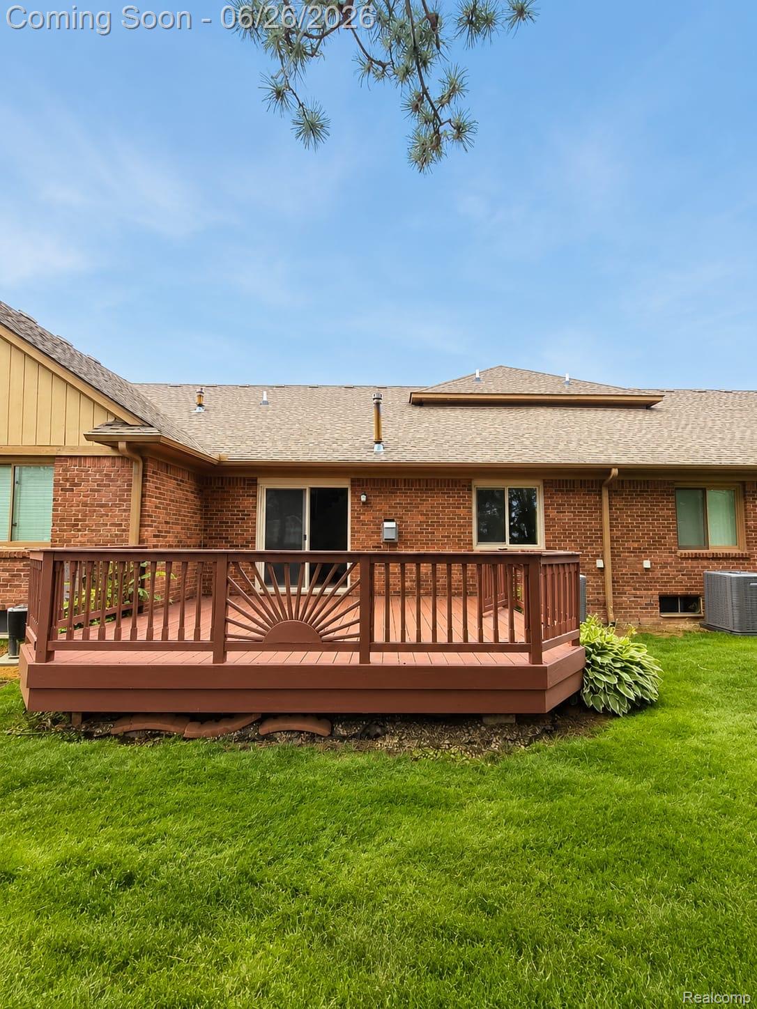 17014 Country Ridge Lane Macomb, MI 48044 - Photo 25 of 25 Expansive wooden deck featuring a decorative sunburst railing insert and direct access to the interior via sliding glass doors