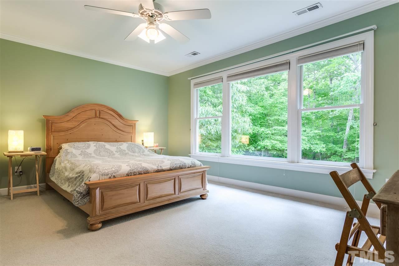 2737 Sunnystone Way Raleigh, NC 27613 - Photo 14 of 24 Master bedroom with large windows, a fabulous view to wake up to in the morning.