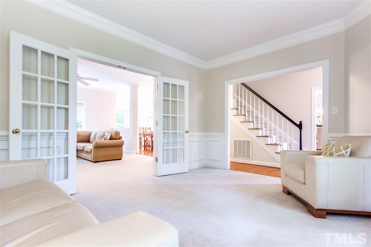 2737 Sunnystone Way Raleigh, NC 27613 - Photo 6 of 24 Spacious Living room or Office with wainscoting, palladian windows and french doors leading to the Family room.