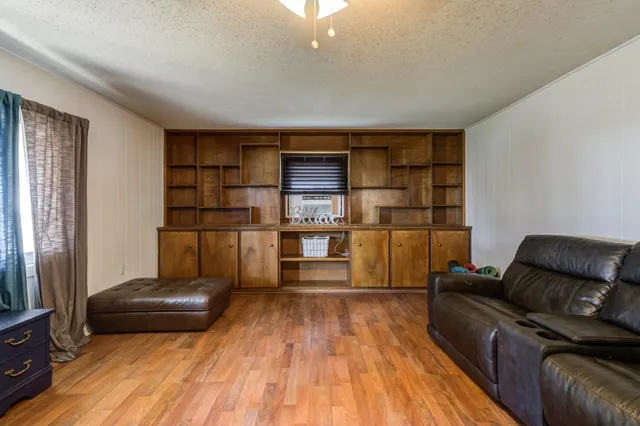 a living room with a couch and a wooden floor