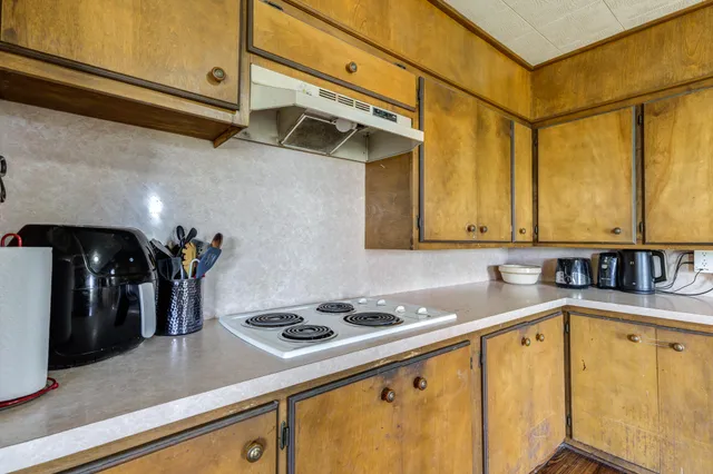 a kitchen with stainless steel appliances granite countertop a sink a stove and refrigerator