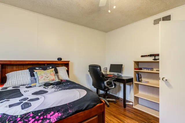a bedroom with a bed and a desk