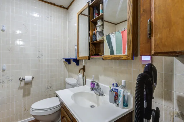 a bathroom with a sink toilet and a mirror