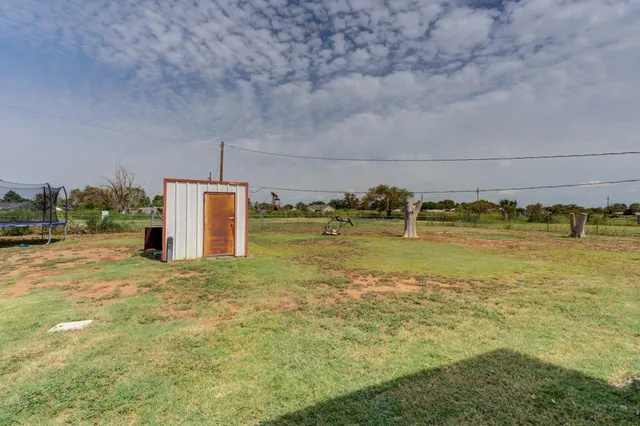 a swimming pool with an outdoor space and seating area