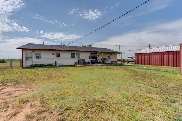 a front view of house with yard barbeque oven and outdoor seating