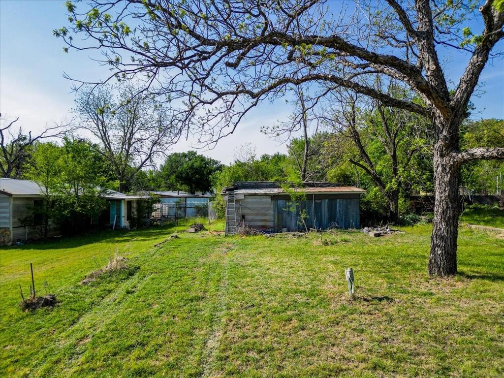 26 Deer Haven Road Gordon, TX 76453 - Photo 5 of 8 RV hookups area with old bait shop behind