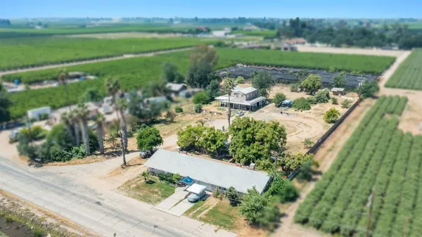an aerial view of a house with a yard and lake view
