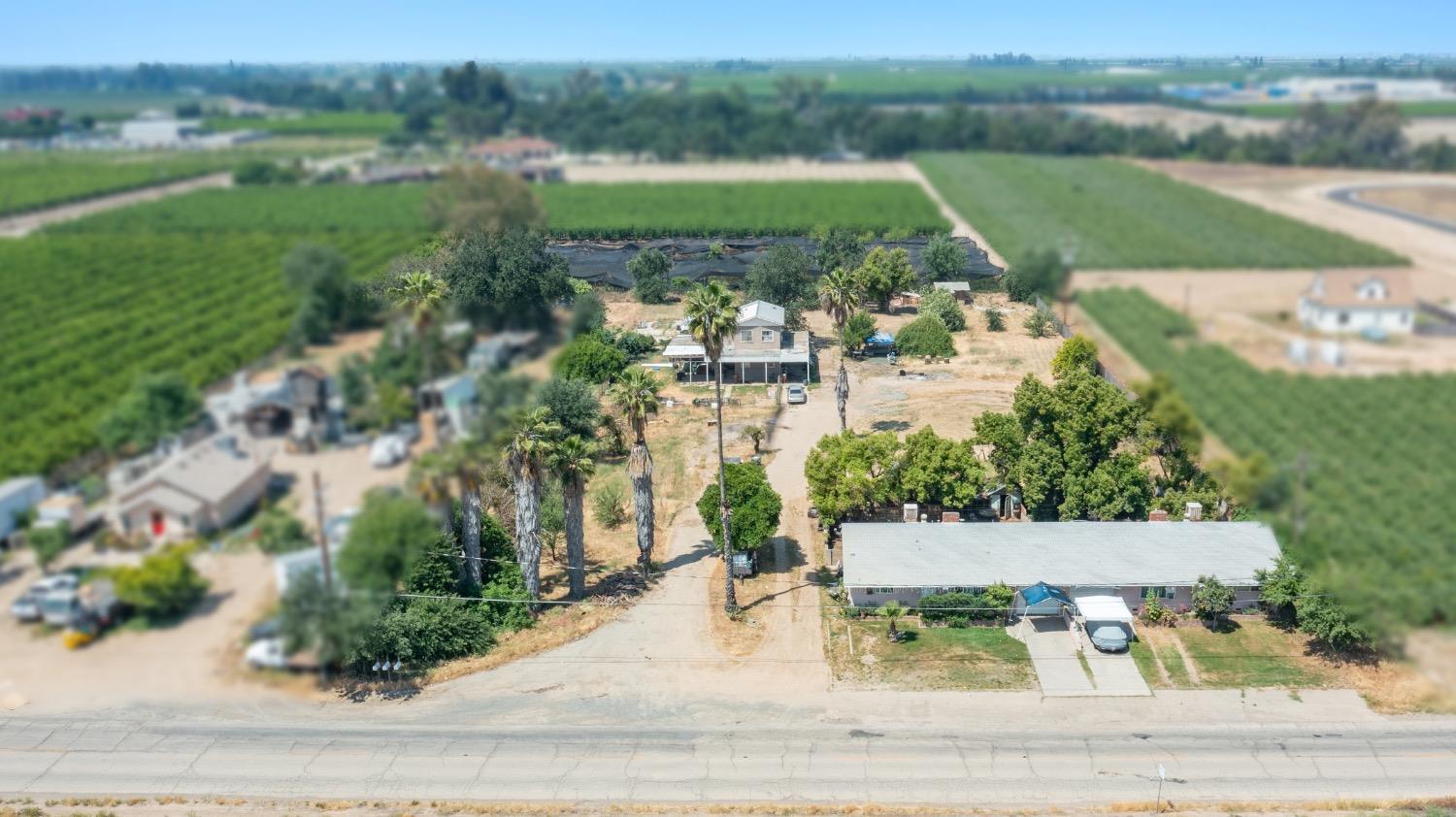 10861 South Reed Avenue Reedley, CA 93654 - Photo 3 of 6 an aerial view of a house with yard and lake view