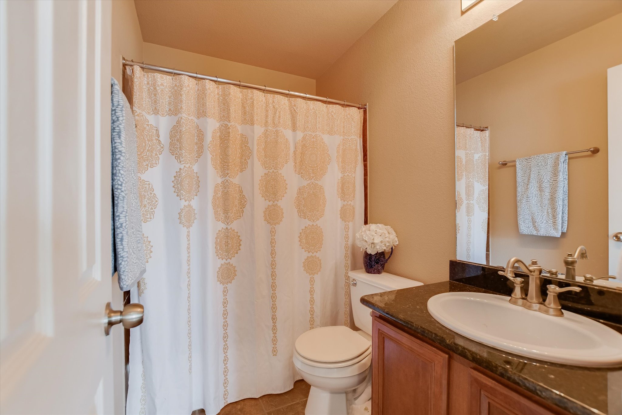 1420 Huckleberry Lane Austin, TX 78748 - Photo 18 of 21 2nd Bathroom featuring vanity, curtained shower, and light tile patterned flooring