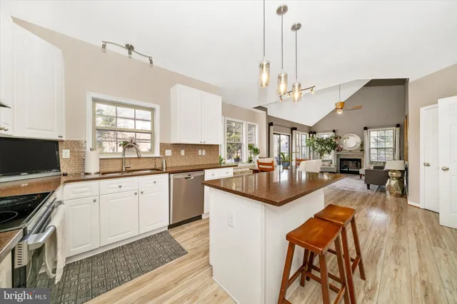 a kitchen with stainless steel appliances kitchen island granite countertop a sink and cabinets