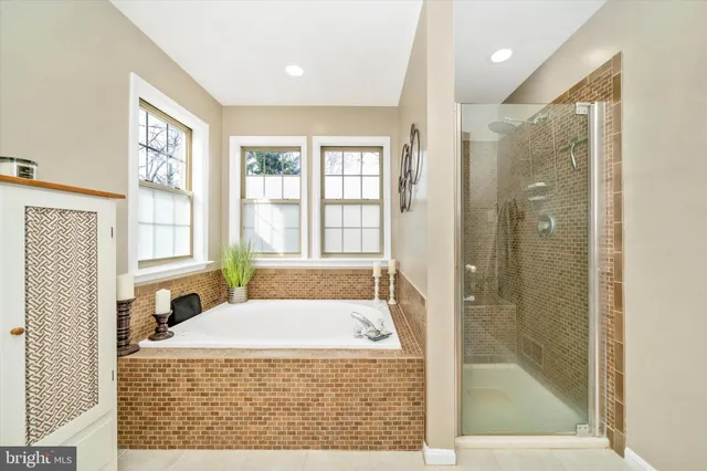 a bathroom with a tub shower and sink