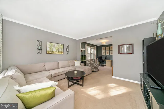 a living room with furniture a couch and a flat screen tv