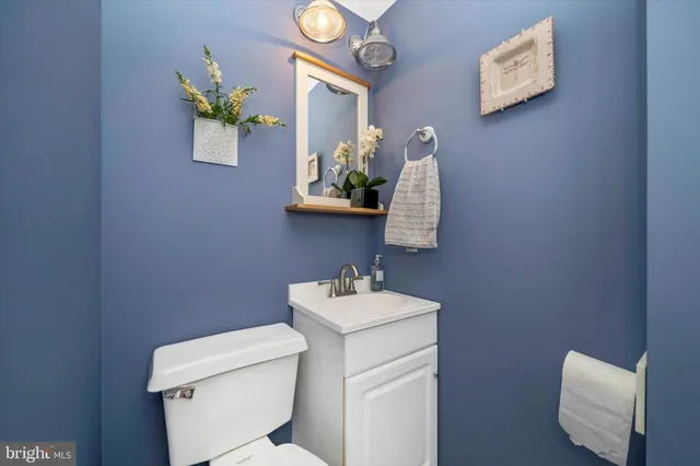 a bathroom with a sink vanity mirror and toilet