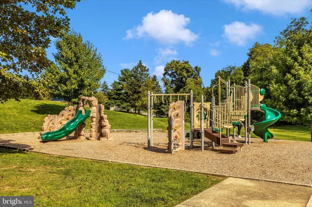 a view of a park with swings and slides