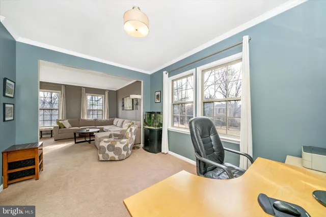 a bedroom with furniture and a large window