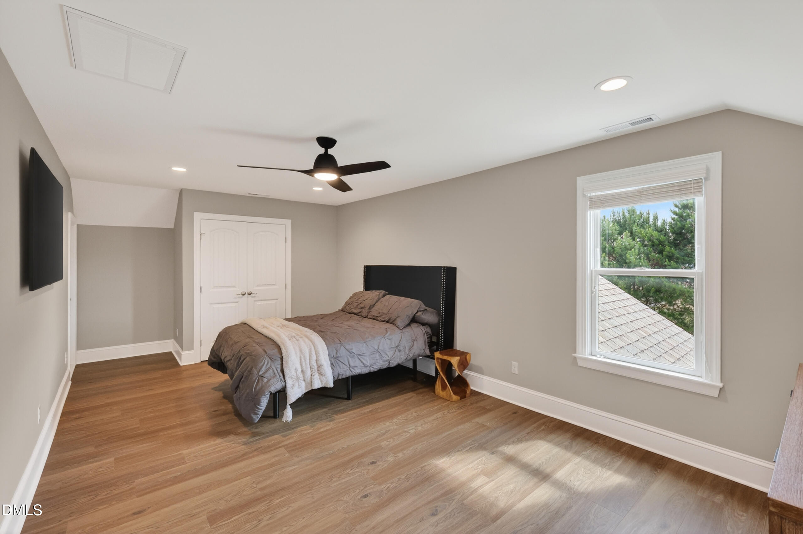261 Character Drive Rolesville, NC 27571 - Photo 52 of 77 a spacious bedroom with a bed and a window