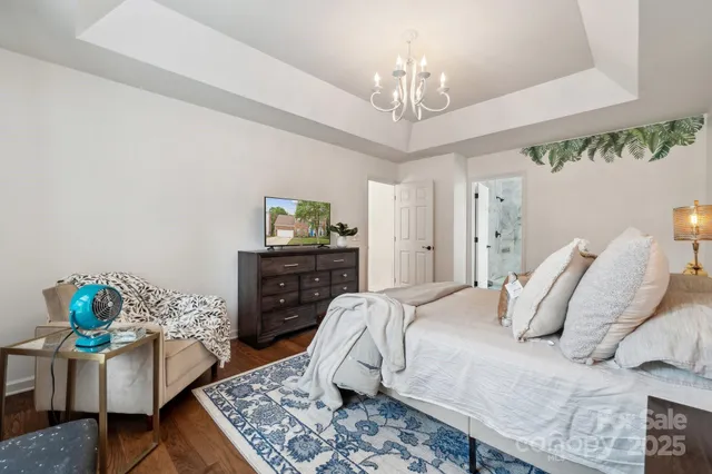 a bedroom with a bed and chandelier