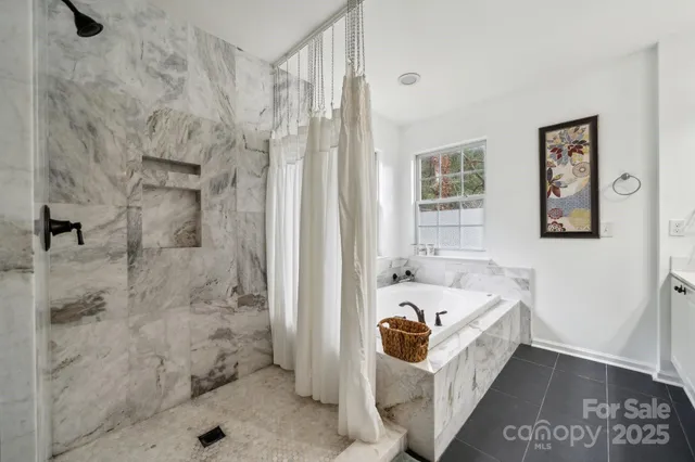 a bathroom with a tub sink and shower