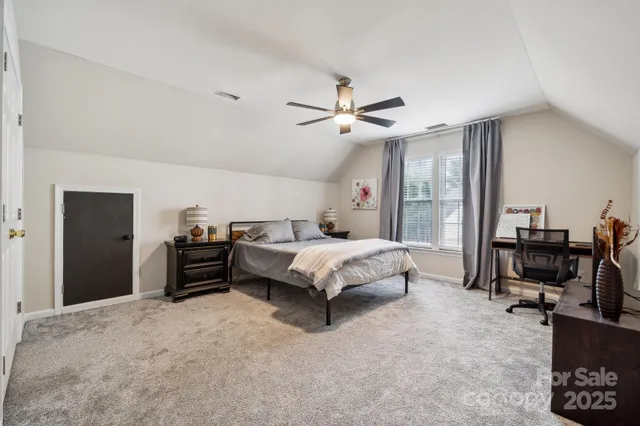 a bedroom with a bed dresser and a desk