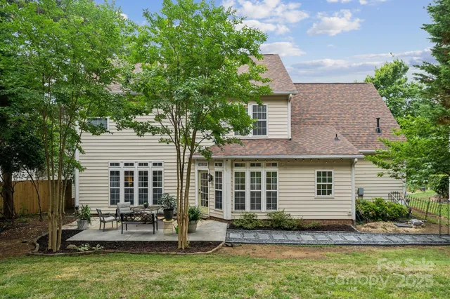 a view of house with backyard and seating area
