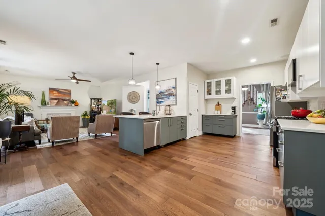 a living room with furniture and kitchen view