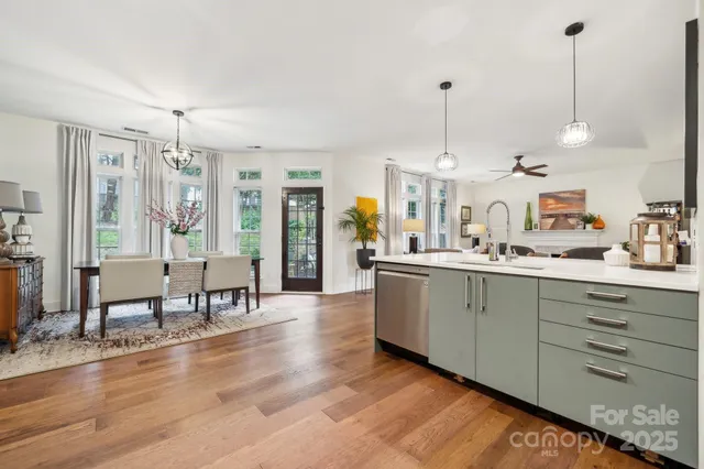 a large kitchen with kitchen island white cabinets and stainless steel appliances