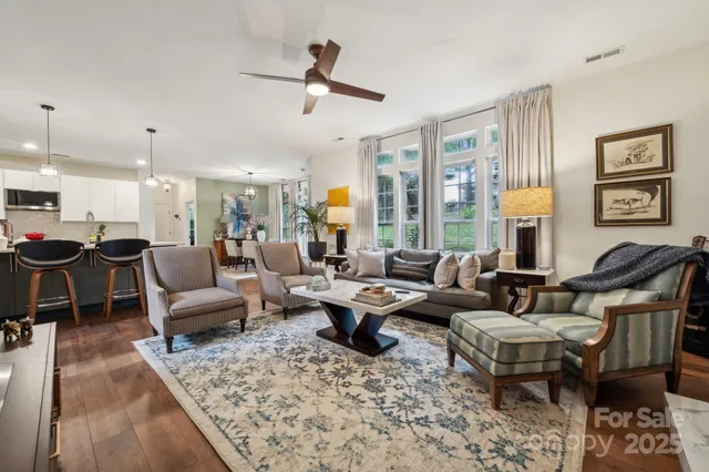 a living room with furniture and a chandelier