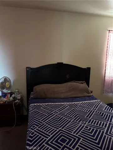 a bedroom with a bed and window