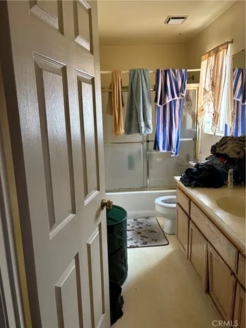 a bathroom with a sink a toilet and a shower