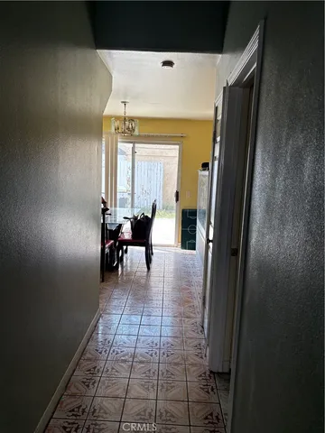 a hallway with dining area and glass door
