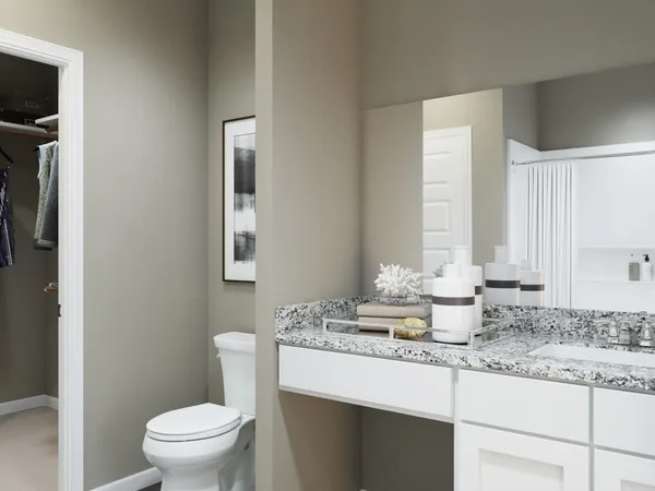 a bathroom with a granite countertop sink toilet and bathtub