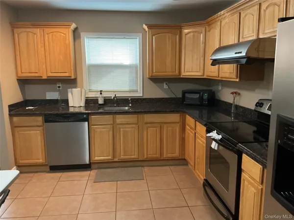 a kitchen with a sink a stove and cabinets