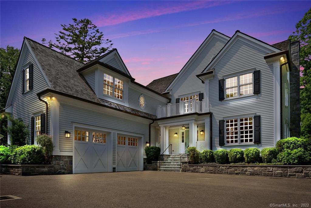 front view of a brick house with a yard