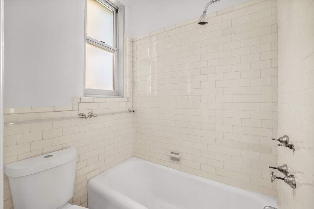 1065 Lexington Avenue, Unit PHA Manhattan, NY 10021 - Photo 6 of 12 a bathroom with a toilet and bathtub