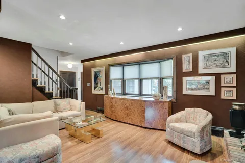a living room with furniture and a hard wood floor