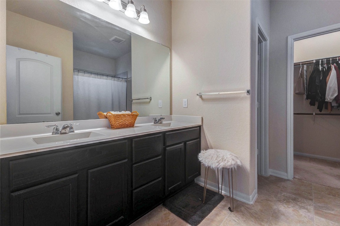 20623 Footstep Path Katy, TX 77449 - Photo 11 of 23 a bathroom with a double vanity sink and a mirror