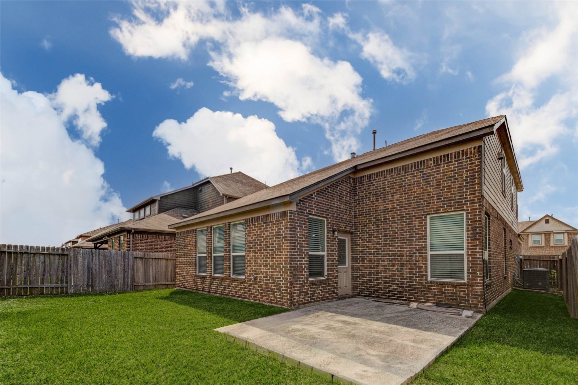 20623 Footstep Path Katy, TX 77449 - Photo 22 of 23 a backyard of a house with large tree plants and wooden fence