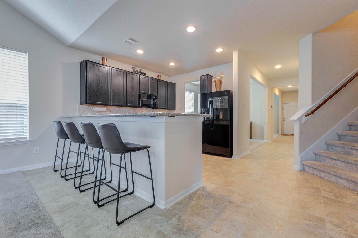 20623 Footstep Path Katy, TX 77449 - Photo 6 of 23 a kitchen with stainless steel appliances kitchen island granite countertop a refrigerator and a stove top oven