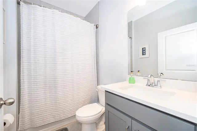 a white bed sitting in a bedroom next to a window